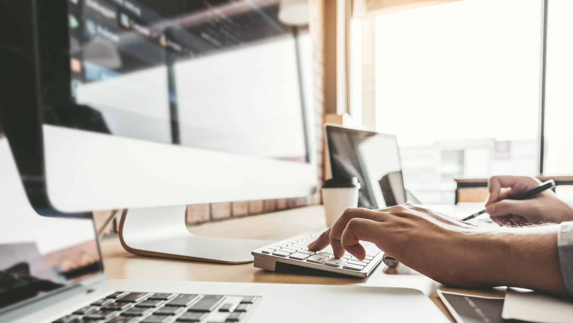 hands-typing-on-keyboard-at-monitor-while-building-future-proof-website-for-business
